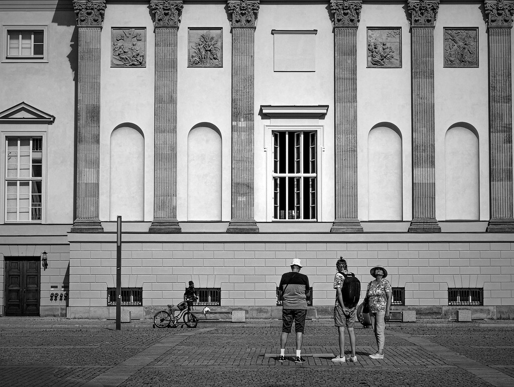 Group of three people on Bebel Platz in Berlin. Street Photography by Sean P. Durham, Berlin, 2021, copyrighted