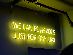 we can be heroes neon sign in green