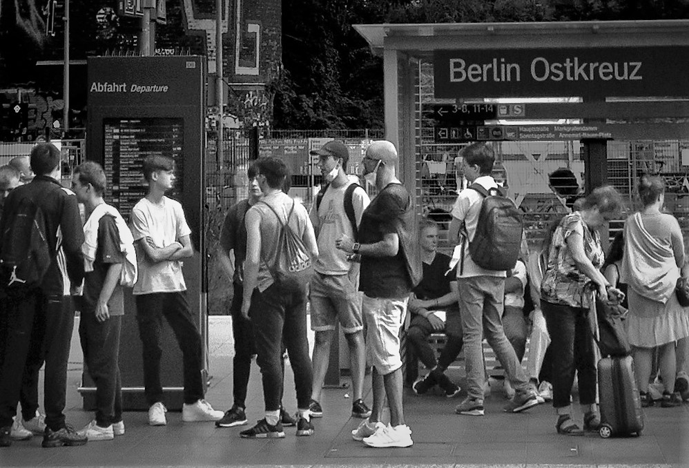 Ostbahnhof group of people waiting for a train in the evening light. Copyright; Sean P. Durham, Berlin, 2022