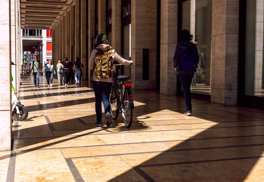 Street Photography in Berlin, 2023. Copyright; Sean P. Durham, Berlin, 2023 man pushing bicycle along Friedrichstrasse Passagen